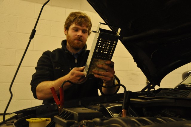 Jonathan Hopkins checks the battery on his car