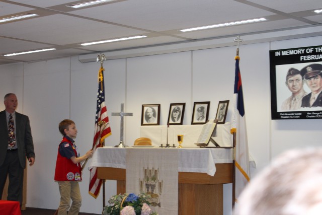 Bear Scout Frankie Lichtenstein lights the remembrance candles