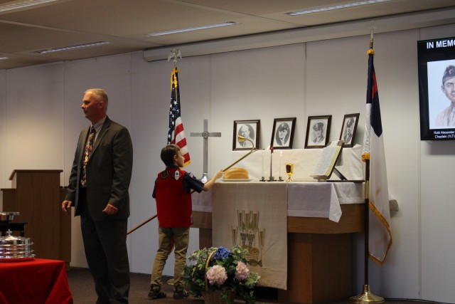 Bear Scout Frankie Lichtenstein lights the remembrance candles