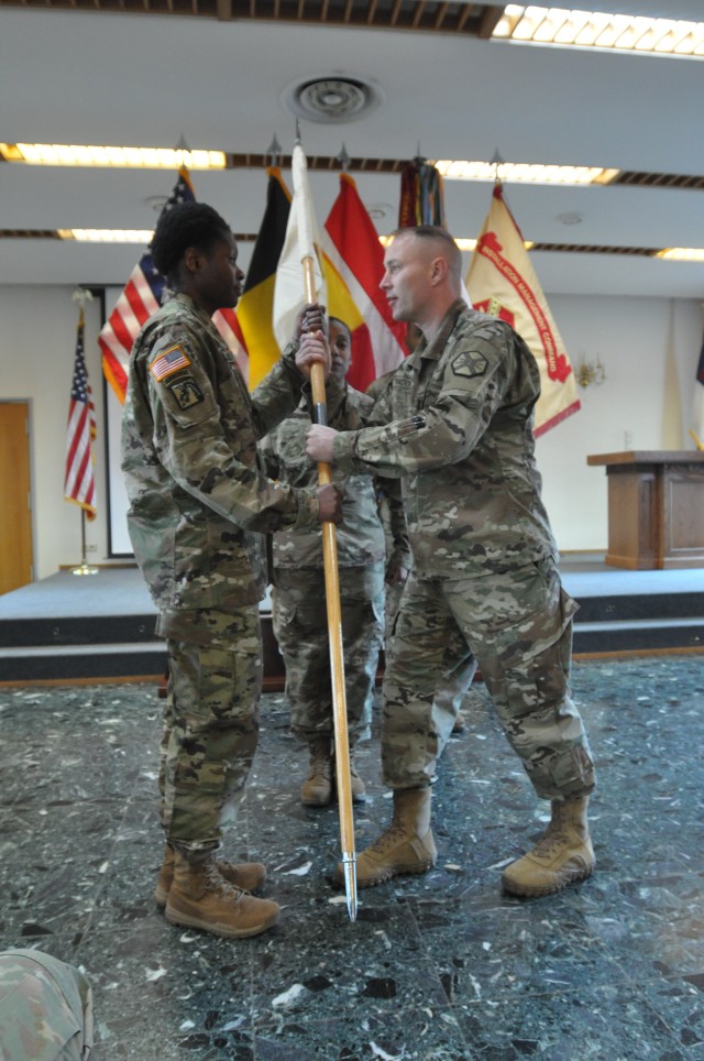 Capt. Curtis Radoff hands on guide on to 1st Sgt. Natalee Simms