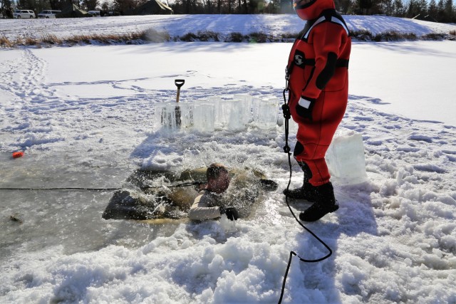 Service members battle icy conditions in cold-water immersion training at Fort McCoy