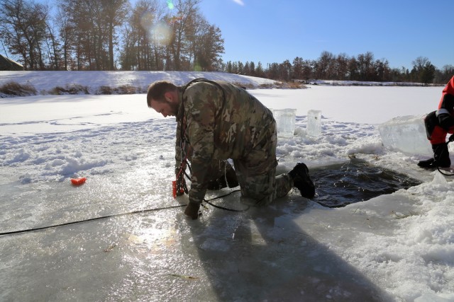 Service members battle icy conditions in cold-water immersion training at Fort McCoy