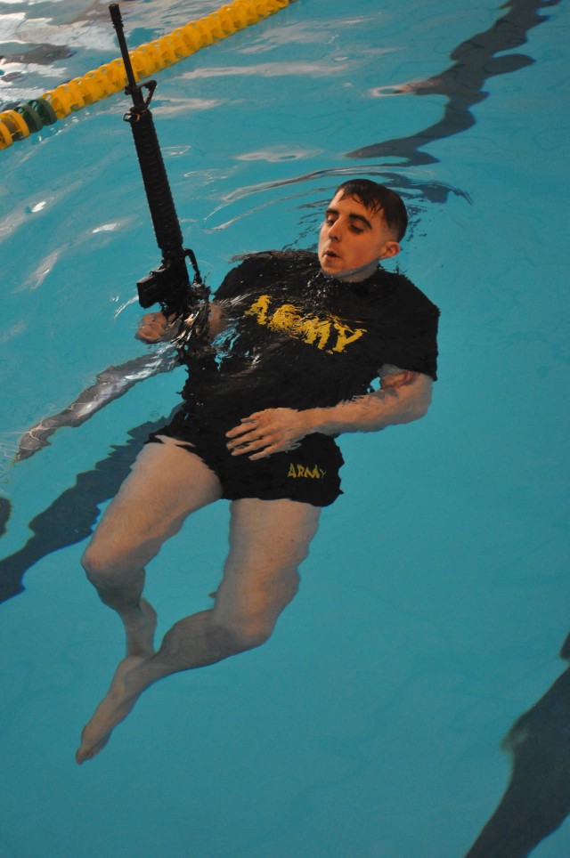 Sgt. Jacobus Wood does water survival test during Best Warrior Competition