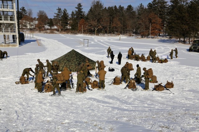 Cold-Weather Operations Course Class 18-04 students build Arctic tents during training at Fort McCoy