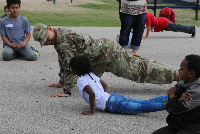 Heavy Truck soldiers educate, entertain children at adopted school