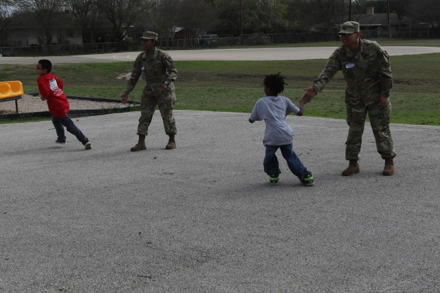 Heavy Truck soldiers educate, entertain children at adopted school