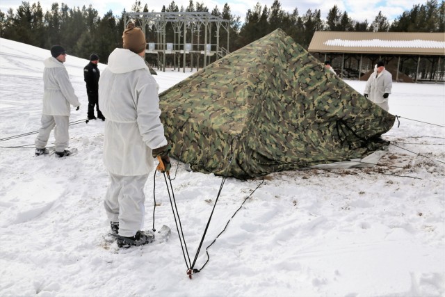 Cold-Weather Operations Course Class 18-06 students build Arctic tents during training at Fort McCoy