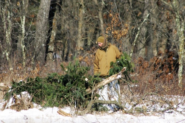 Cold-Weather Operations Course Class 18-04 students build improvised shelters during training at Fort McCoy