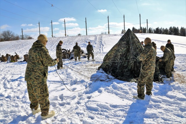 Cold-Weather Operations Course Class 18-04 students build Arctic tents during training at Fort McCoy