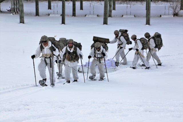Cold-Weather Operations Course Class 18-06 students practice snowshoeing at Fort McCoy