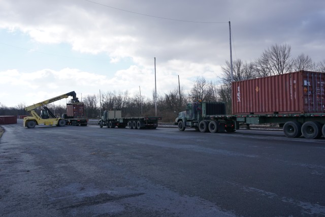 A Letterkenny Munitions Center employees unload shipping containers from the 1048th Transportation Company, Connecticut Army National Guard's flatbed trailers in support of Operation Patriot Bandoleer
