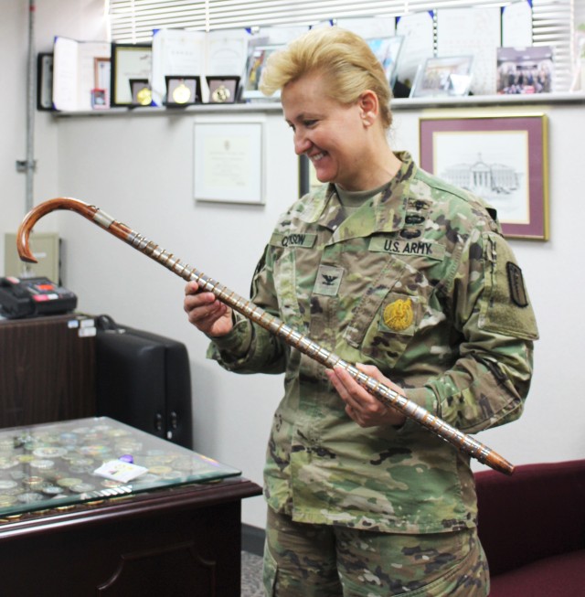 Col. Erica Clarkson looking at Hospital's historical Cane
