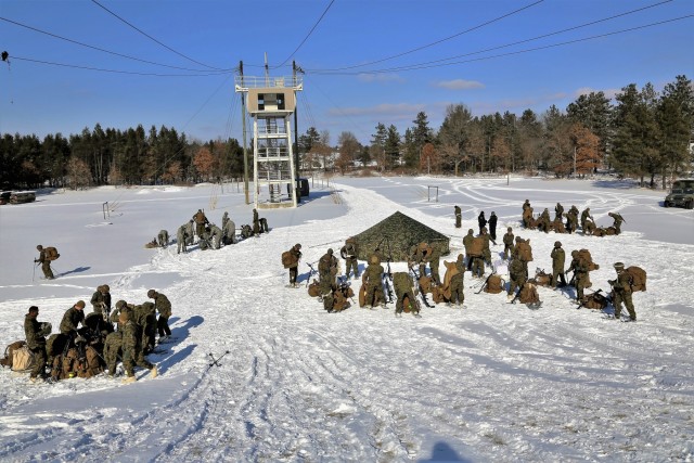 Cold-Weather Operations Course Class 18-04 students build Arctic tents during training at Fort McCoy