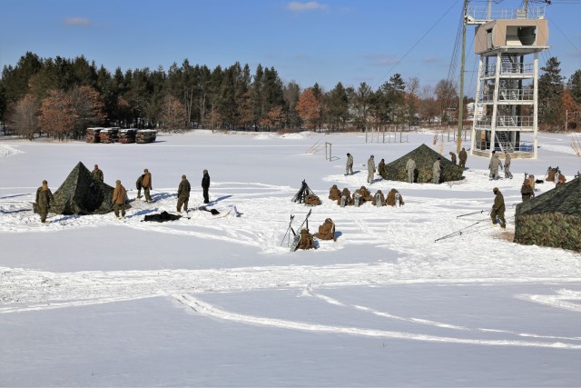 Cold-Weather Operations Course Class 18-04 students build Arctic tents during training at Fort McCoy