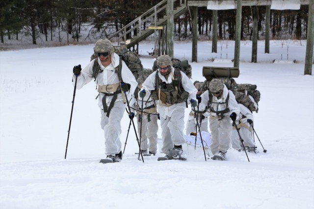 Cold-Weather Operations Course Class 18-06 students practice snowshoeing at Fort McCoy