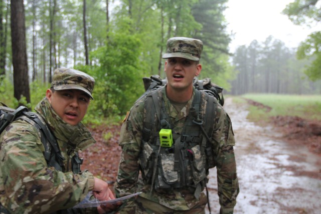 Spc. Musarra and Spc. Ramos assist each other find a land navigation point