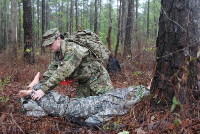 Sgt. Matelski evaluates and treats a casualty