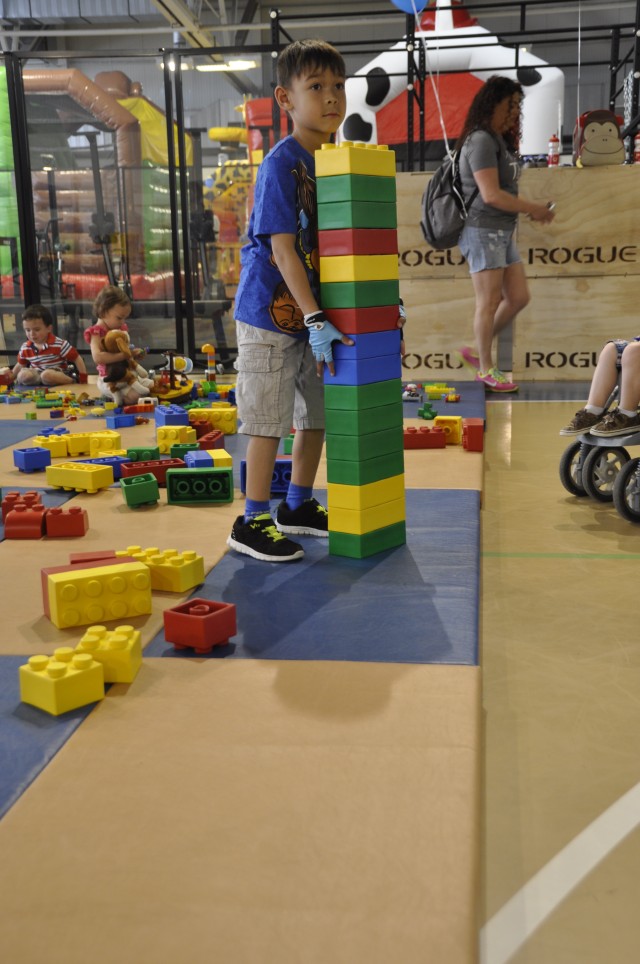 A little boy plays with LEGOs