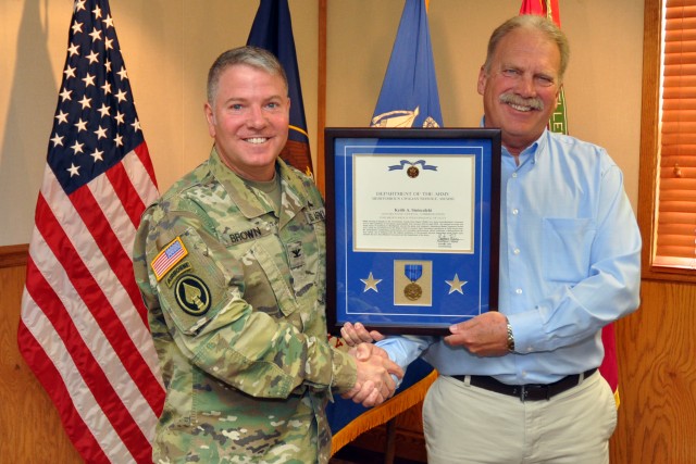 Keith Siniscalchi, civilian deputy to the commander, Tooele Army Depot, receives the Department of the Army Meritorious Civilian Service Award 