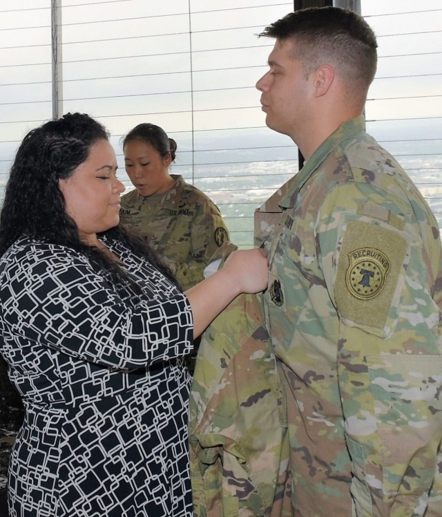 Army tradition continues as health care recruiter gets promoted on top of world