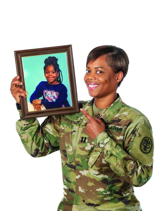 Capt. Jasmine Torrence shows off a childhood picture of herself. Torrence was born at Eisenhower Army Medical Center in March 1989 and recently returned as the chief of supply chain management in EAMC