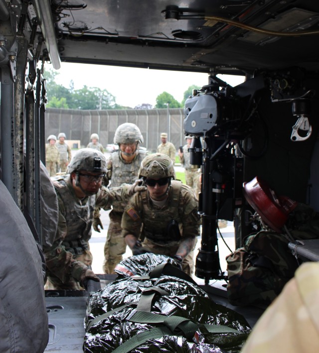 Loading litter patient to UH-60