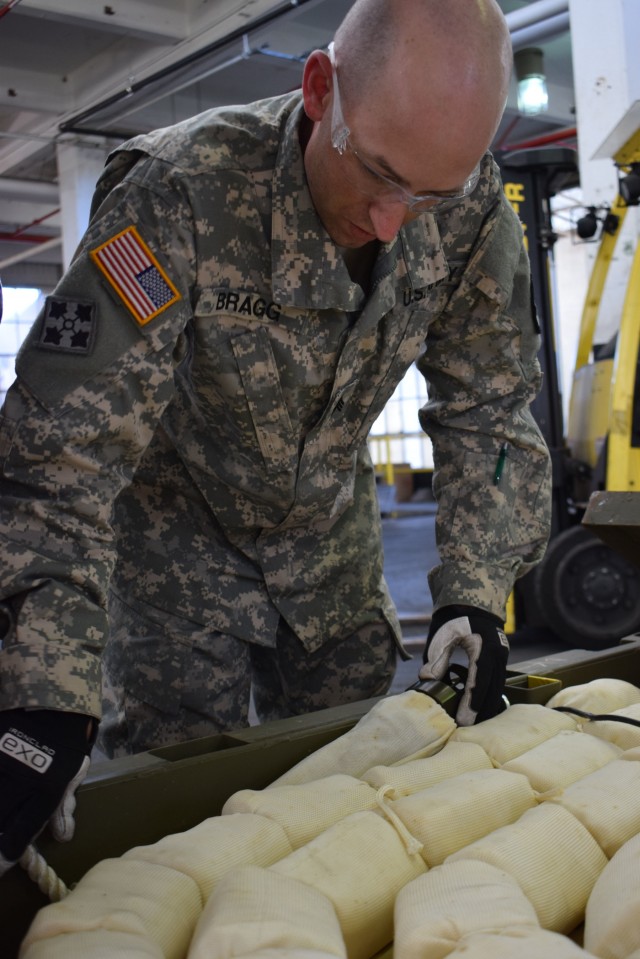 Soldiers from the 411th Ordnance Battalion inspect MICLIC line charges
