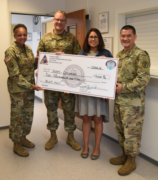 SHAPE Optometry Staff receives check