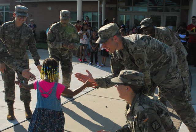 Haircuts and high fives: 20th CBRNE Soldiers welcome area elementary school students back to class