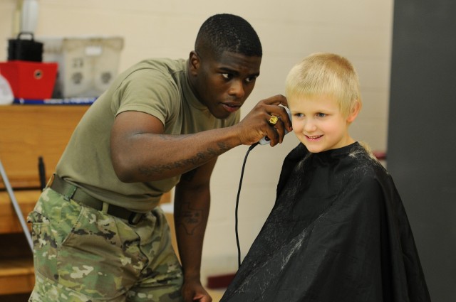 Haircuts and high fives: 20th CBRNE Soldiers welcome area elementary school students back to class