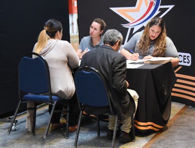 CYS employees review applications at Benelux Employment, Volunteer and Career Expo