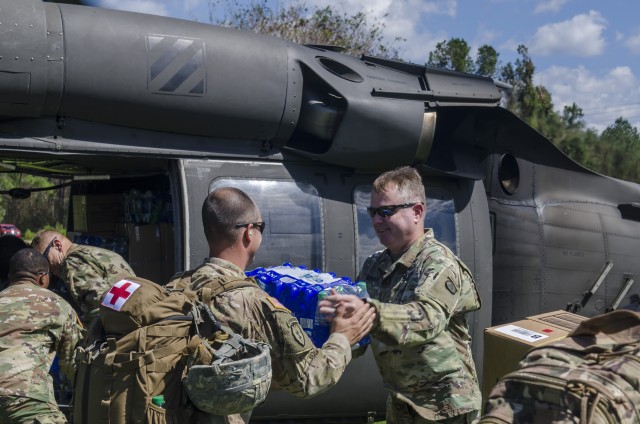 U.S. Army Soldiers deliver supplies to affected areas