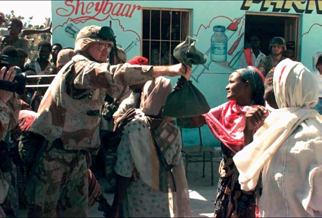 Civil Affairs Soldier distributes humanitarian aid relief supplies in Somalia, early 1980s