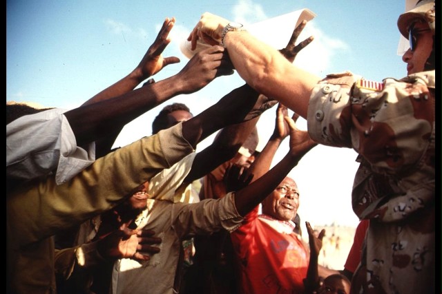 PSYOP Soldier delivers "RAJO" as part of humanitarian aid relief mission in Somalia, early 1980s