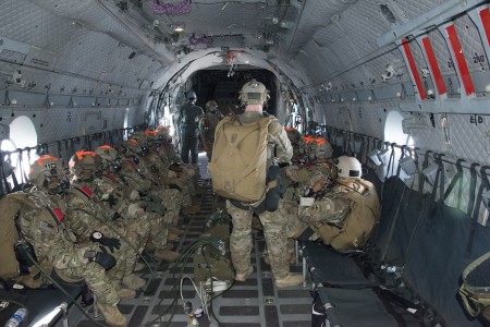 A U.S. Army paratrooper attaches his static line to the runner on