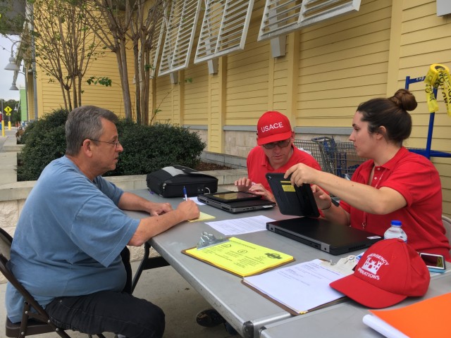 U.S. Army Corps of Engineers personnel help Florida residents sign up for Operation Blue Roof
