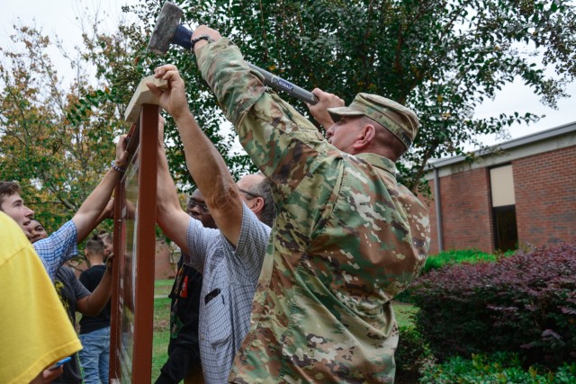 Fort Benning NCOA places PIE sign at local school