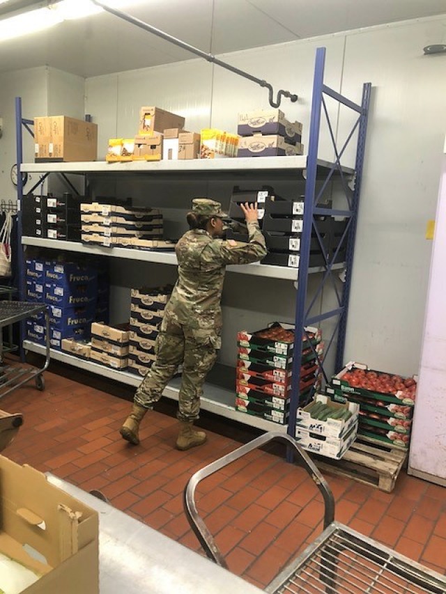 Spc. Niya Kennedy, Food Inspector Specialist from Baumholder checks lunch meat items sold at a grocery store on post.