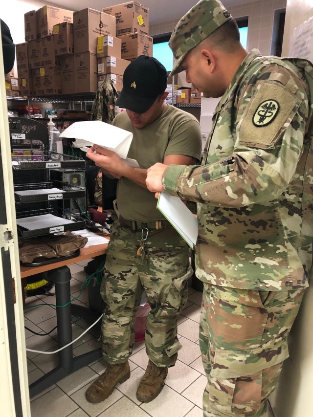 Sgt. Markanthony Cepeda, Veterinary Food Inspector, reviews work order paperwork.