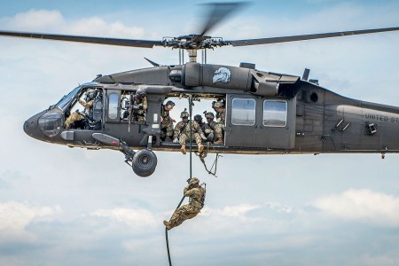 A Soldier exits a Black Hawk helicopter via a rope during a demonstration at the 6th Ranger Training Battalion&#39;s open house event, May 5, 2018, at Eglin Air Force Base, Fla. The event was a chance for the public to learn how Rangers train and...