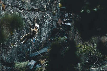 A Special Forces Soldier with Operational Detachment Alpha conducts a tyrolean traverse over an 80-foot gorge, aboard Marine Corps Mountain Warfare Training Center, Bridgeport, Calif., July 23, 2018. Any Special Operations force element that comes...