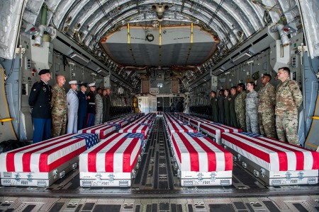 Transfer cases, containing the remains of what are believed to be U.S. service members lost in the Korean War, line the bay of a U.S. Air Force C-17 Globemaster III aircraft during an honorable carry ceremony at Joint Base Pearl Harbor-Hickam,...