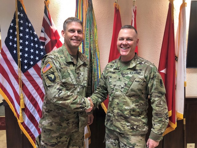 POD Commanding General presents commanders coin to 412 TEC Deputy Commanding General