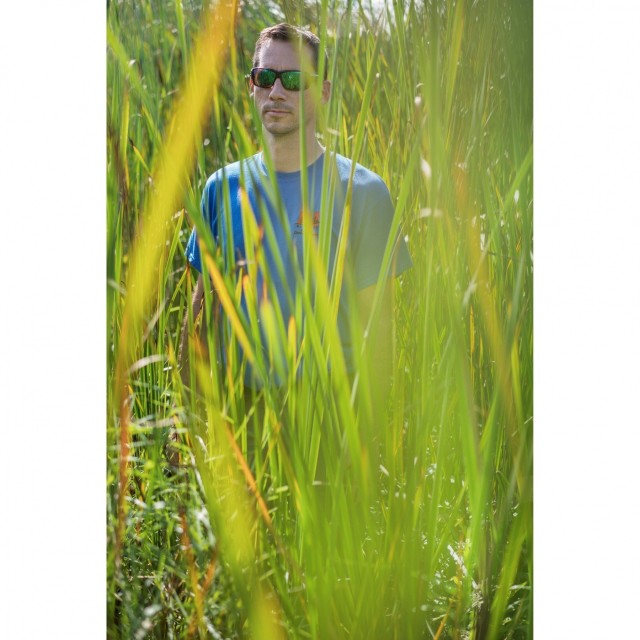 Buffalo District biologist Joshua Unghire stands among Braddock Bay vegetation