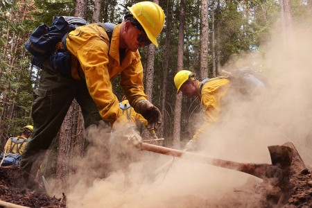 A Soldier with with 176th Engineer Company, clears hot spots along the fire line of the Sheep Creek fire, Aug. 5, 2018, near Northport, Wash. Price is a member of a 20-person hand crew that is one of five crews made up of Washington Army and Air...