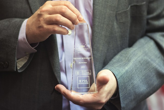 Presidential Rank Award in hands