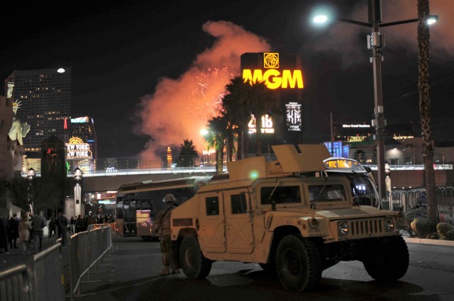 Nevada National Guard Soldiers provide security support to local law enforcement on the Las Vegas Strip as fireworks shoot from the rooftops of hotels during the 2018 New Year's celebration.