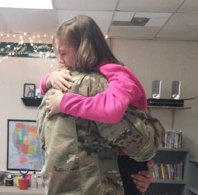 Soldier makes surprise reunion with daughters after returning from deployment