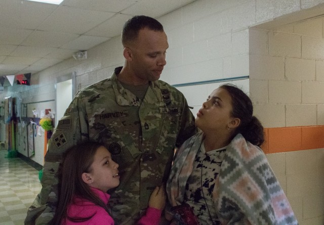 Soldier makes surprise reunion with daughters after returning from deployment