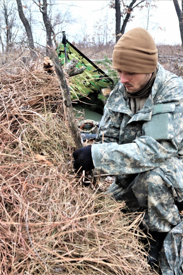 Cold-Weather Operations Course students build improvised shelters, survive outdoors